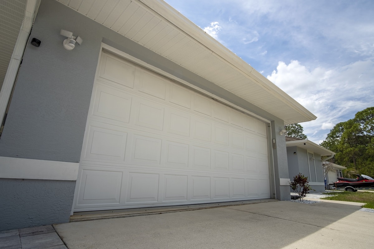 Wide garage double door and concrete driveway of new modern american house